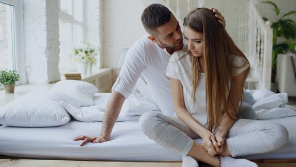 Couple in bed sitting together